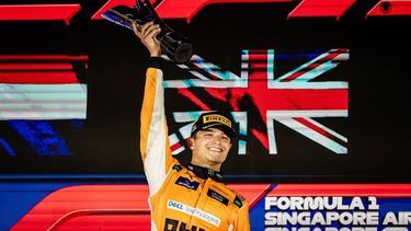 epa11619155 British driver Lando Norris of McLaren F1 Team celebrates on the podium after winning the Singapore Formula One Grand Prix at the Marina Bay Street Circuit, Singapore, 22 September 2024.  EPA/TOM WHITE