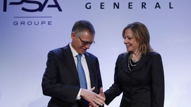 Carlos Tavares, Chairman of the Managing Board of French carmaker PSA Peugeot Citroen, shakes hands with Mary Barra, chairwoman and CEO of General Motors, before a news conference in Paris