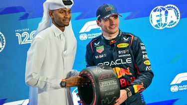 Red Bull Racing's Dutch driver Max Verstappen (R) receives the pole position trophy from Qatar's track and field athlete Mutaz Essa Barshim at the end of the qualifying session of the Qatari Formula One Grand Prix at the Lusail International Circuit in Lusail, north of Doha, on November 30, 2024. 
Giuseppe CACACE / AFP