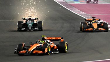 Mercedes' British driver George Russell (L) McLaren's Australian driver Oscar Piastri (R) and McLaren's British driver Lando Norris race during the sprint race ahead of the Qatari Formula One Grand Prix at the Lusail International Circuit in Lusail, north of Doha, on November 30, 2024. 
Mahmud HAMS / AFP