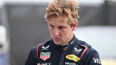 Red Bull Racing's New Zealand driver Liam Lawson walks back to his team garage after getting out of his car at the end of the Formula One Chinese Grand Prix in Shanghai on March 23, 2025. 
GREG BAKER / AFP