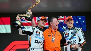 McLaren's British driver Lando Norris (L) lifts his trophy in the air as he celebrates winning the Formula One Monaco Grand Prix on the podium with McLaren's CEO Zak Brown (C) and third-placed McLaren's Australian driver Oscar Piastri (R) at the Circuit de Monaco, on May 25, 2025. 
Andrej ISAKOVIC / AFP