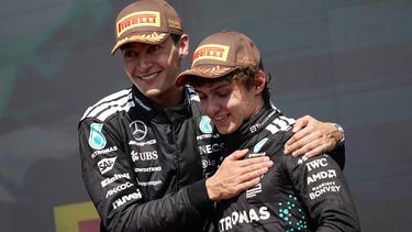 (L/R) Race winner Mercedes' British driver George Russell celebrates with teammate and third place finisher Mercedes' Italian driver Kimi Antonelli on the podium after the 2025 Formula 1 Grand Prix du Canada at Circuit Gilles-Villeneuve in Montreal, Canada, on June 15, 2025.  
Geoff Robins / AFP