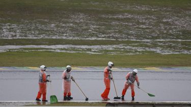 Marshals sweep the track after heavy rain fell at the Jose Carlos Pace racetrack, aka Interlagos, which forced the qualifying session for the upcoming Formula One Sao Paulo Grand Prix to be delayed, in Sao Paulo, Brazil, on November 2, 2024. 
Miguel Schincariol / AFP