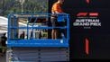A worker stands on a hydraulic platform during preparations and contruction work at the paddock of the Red Bull Ring race track in Spielberg, Austria on June 24, 2026, ahead of the Formula One Austrian Grand Prix. 
ERWIN SCHERIAU / APA / AFP