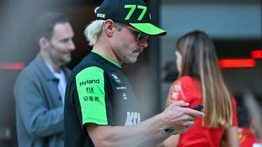 Kick Sauber's Finnish driver Valtteri Bottas checks his mobile phone as he arrives at Lusail International Circuit in Lusail, north of Doha, ahead of the first practice session of the Qatari Formula One Grand Prix on November 29, 2024. 
Andrej ISAKOVIC / AFP