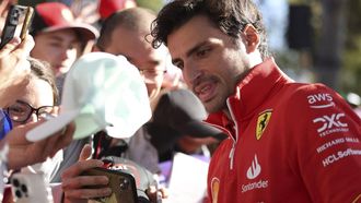 Ferrari's Spanish driver Carlos Sainz Jr poses for photos with fans at the Albert Park Circuit ahead of the Formula One Australian Grand Prix in Melbourne on March 21, 2024. 
Martin KEEP / AFP